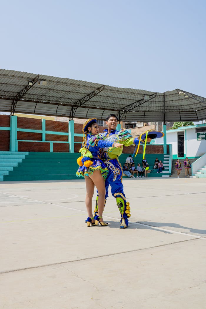 menu-01 Colorful Caporales dancers performing at an outdoor stadium in Lima, Peru, showcasing vibrant traditional costumes.