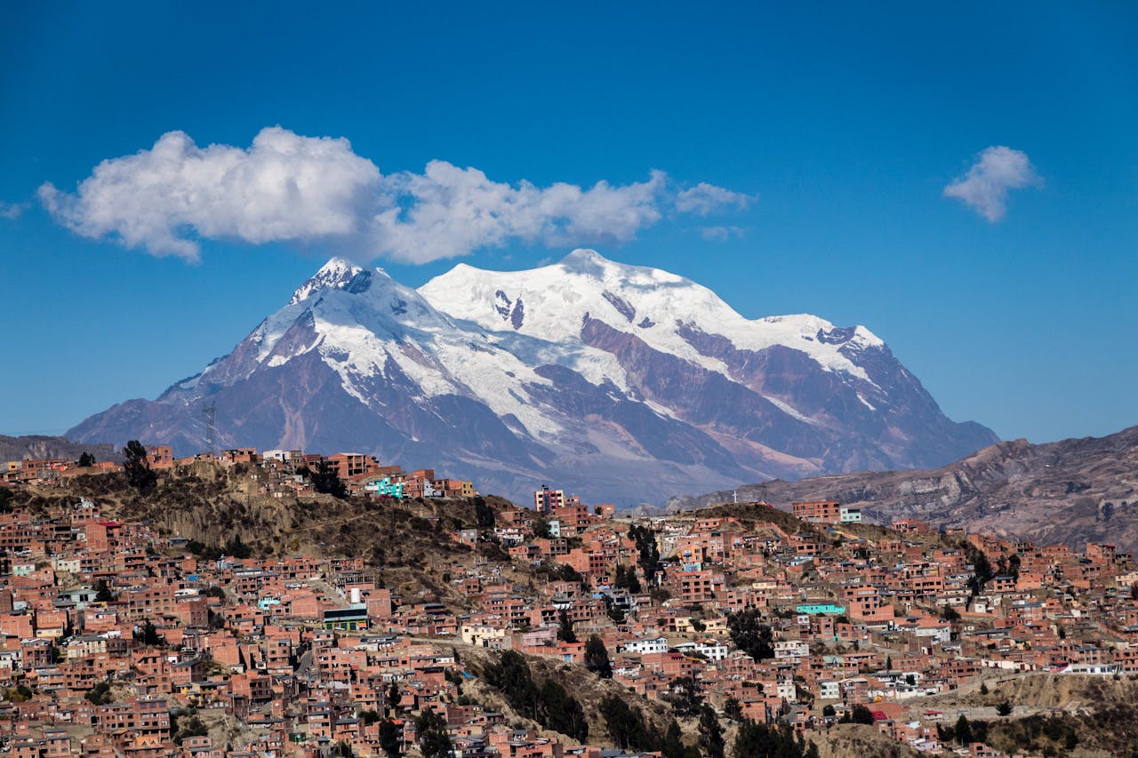 about-04 Panoramic view of snow-capped Illimani Mountain towering over the vibrant cityscape of La Paz, Bolivia.